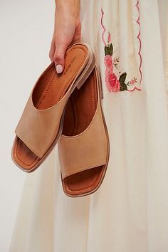 Simple and so chic, these slip-on sandals feature a pebbled-leather toe strap with a square open toe and minimal heel for a style that’s as stylish as it is comfortable. **Features:** Slip-on style, backless design, pebbled leather toe strap, square open toe, lined footbed, low heel **Why We | Essential Slip-On Sandals by FP Collection at Free People in Brown, Size: US 8 Elegant Square Toe Summer Slides, Classic Single Toe Strap Mules For Spring, Classic Spring Mules With Single Toe Strap, Summer Square Toe Mules With Leather Footbed, Chic Summer Mules With Leather Sole, Chic Sandals With Leather Footbed And Square Toe, Chic Everyday Sandals With Leather Footbed, Chic Square Toe Sandals With Leather Footbed, Leather Footbed Mules For Everyday Wear