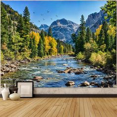 a river with mountains in the background and trees on both sides, surrounded by wood flooring