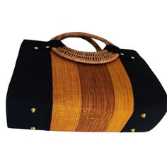 If you love elegant and classy handbags and love making a statement then this bag is for you! With sturdy and gorgeous cane handles and a stunning combination of colors from the Fugu fabric, the bag is practically royalty. The Fugu or Smock fabric is a luxury native fabric worn mostly by the royals of the Northern Tribes of Ghana. This bag also comes with an inner pocket with a zip fastening and provides lots of space, it's even big enough for a small laptop! As if that was not awesome enough, w Elegant Top Handle Beach Bag, Elegant Box Bag With Braided Double Handles, Shopping Straw Bag With Bamboo Handle, Elegant Beach Bag With Leather Handles, Elegant Rectangular Canvas Bag With Top Carry Handle, Elegant Satchel Beach Bag With Handles, Elegant Brown Canvas Bag With Top Handle, Black Shoulder Bag With Bamboo Handle For Travel, Black Travel Shoulder Bag With Bamboo Handle