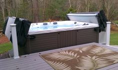 a hot tub sitting on top of a wooden deck