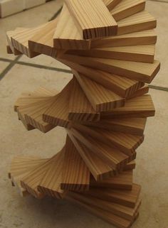 several pieces of wood stacked on top of each other in the shape of a spiral