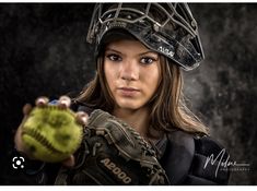 a woman wearing a catchers mitt holding a ball