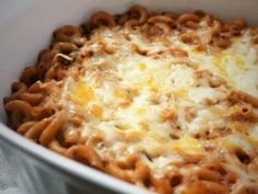 a casserole dish with cheese and meat in it