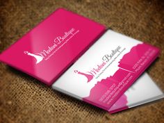 two business cards for a women's boutique on a brown carpeted surface with pink and white accents