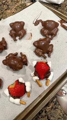 chocolate covered strawberries and marshmallows on a baking sheet