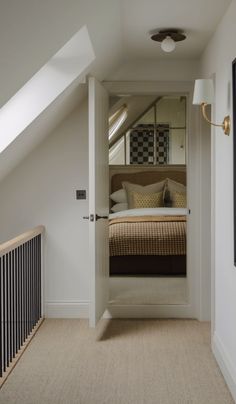 an open door leading to a bedroom with a bed in it