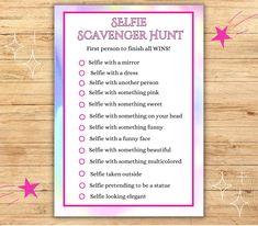 a selfie scavenger hunt is shown on a wooden table with pink stars