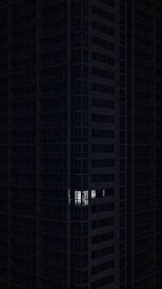 two windows are lit up in the dark