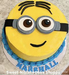 a birthday cake decorated to look like a minion