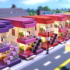 an animated city with lots of colorful buildings and plants on the balconies in front of them