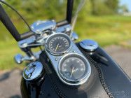 the handlebars and gauges of a motorcycle are visible in this photo,