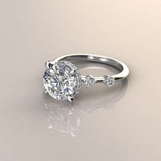 a diamond engagement ring with three stones on the band and an oval shaped center stone