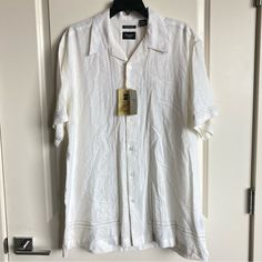 This Men’s Haggar Button Down Shirt Is Made With Linen And Rayon And Is New With Tags, It Has These Beautiful Embroidery Accents. There Is A Small Faint Spot In The Last Photo But I Think It Could Be Easily Washed Out. Otherwise Great Condition Leave A Comment If You Have Any Questions White Camp Shirt With Spread Collar And Button Closure, White Camp Shirt With Button Closure And Relaxed Fit, White Camp Shirt With Spread Collar, Classic Button-up Camp Shirt For Beach, White Relaxed Fit Camp Shirt With Button Closure, Classic Beach Camp Shirt Button-up, Classic Collared Shirt For Vacation, White Button-up Camp Shirt With Placket, White Camp Shirt With Camp Collar