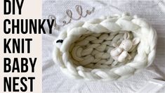 there is a knitted baby nest with a teddy bear in it and the words, diy chunk knit baby nest