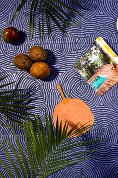 there are some fruit and an umbrella on the table with it's blue cover