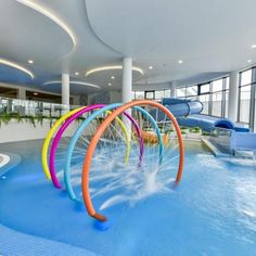 an indoor swimming pool with water slides in the background