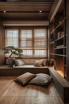 a living room filled with lots of furniture and pillows on top of wooden flooring