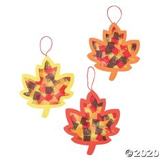 three autumn leaf shaped decorations hanging from strings