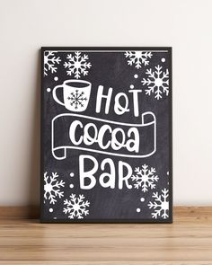 a sign that says hot cocoa bar with snowflakes on the bottom and below it