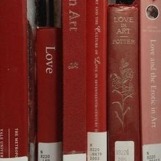 a row of red books sitting on top of each other