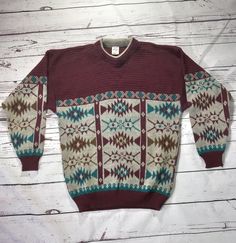 This jumper/ sweater is so cosy on. Perfect for those colder days. Would make an ideal sustainable christmas gift. The jumper is mainly deep Burgandy in colour with a large Aztec type of print in Burgandy, light grey/ silver, teal blue and a greenish brown, cuffs hem and collar all in excellent condition. Will fit up to approx. size 18 in UK women's sizing - but please check measurements. Made by: Classic Man Size Label: none Measurements (pit to pit): 22inches Measurements (shoulder to hem):28 Casual Patterned Sweater For Winter, Patterned Crew Neck Winter Top, Winter Patterned Crew Neck Top, Winter Patterned Knitted Sweater, Patterned Knitted Sweater For Winter, Winter Knitted Patterned Sweater, Cozy Patterned Long Sleeve Sweater, Scandinavian Crew Neck Sweater For Winter, Fair Isle Sweater For Cold Weather