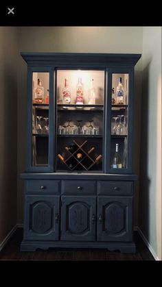 an old china cabinet with wine bottles in it