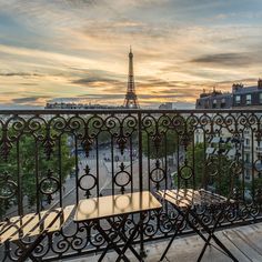 a balcony overlooking the eiffel tower at sunset