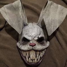 a creepy mask with an evil look on it