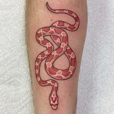 a red snake tattoo on the leg