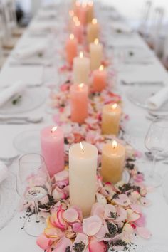 a long table with candles and flowers on it