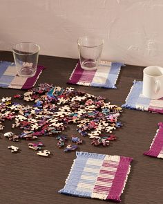 the table is covered with pieces of puzzle