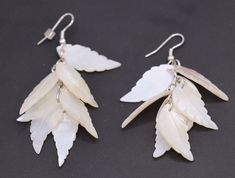 Pretty off white leave leaf dangle earrings.  Silver tone setting with silver hook.  These are a drop dangle style.  For pierced ears only. Earrings measure around  2 1/4" in length (not including front of hook)  Not 100% sure what they are made of.  They feel like an acrylic of some type.  Great quality. Handmade White Leaf-shaped Earrings, White Dangle Earrings With French Hook, White Drop Earrings With French Hook, White Leaf-shaped Earrings With Ear Wire, Dangle Earrings Silver, White Leaf, Drop Dangle Earrings, Boston Ma, Etsy Earrings Dangle