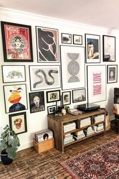 a living room filled with lots of framed pictures on the wall above a coffee table