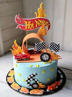 a birthday cake with a hot wheels theme on the top and flames coming out of it