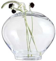 a clear vase filled with water and flowers on top of it's side,