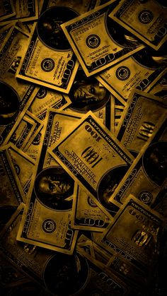 a pile of money sitting on top of each other in front of a black background