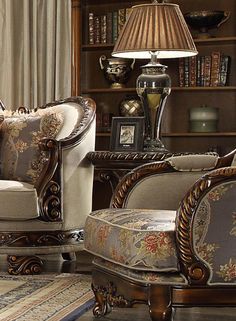 a living room filled with furniture next to a book shelf and lamp on top of a table