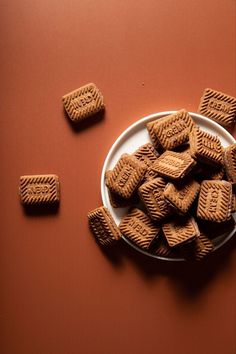 some cookies are on a plate and scattered around