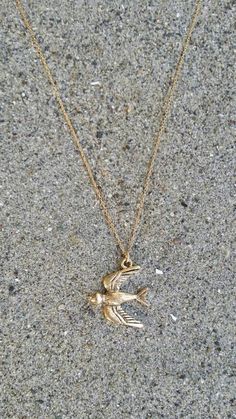 The gold plated charm is 20m x 21mm with an antiqued finish. It  has a delicate 14K gold fill chain with a gold fill clasp in back. Shown here in 17" length.Also available in silver and found here:https://www.etsy.com/listing/268534721/bird-necklace-bird-pendant-silver-bird?ref=shop_home_active_12&pro=1&frs=1*If you are unsure of the length you need, or would like to wear this item at different lengths, we now offer an adjustable length option! You can add an adjustable end to your neckl Vintage Recycled Gold Jewelry As A Gift, Vintage Recycled Gold Jewelry Gift, Dainty Gold Charm Necklace With Vintage Charm, Gold Dainty Charm Necklace With Vintage Charm, Vintage 14k Gold Necklace With Adjustable Chain, Dainty Engraved Brass Charm Necklaces, Antique Gold Necklaces With Charms, Everyday Vintage Gold Plated Necklaces, Everyday Vintage Style Gold Plated Necklace