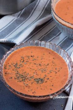 two bowls filled with soup on top of a table