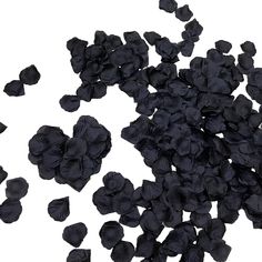 a pile of black flowers on top of a white surface