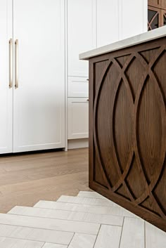 a kitchen with white cabinets and wooden counter tops, along with an area rug on the floor