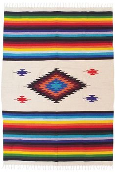 a multicolored blanket with fringes on it