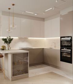 a modern kitchen with white cabinets and marble counter tops