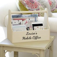 a table with a wooden holder filled with cards and magazines on it's side