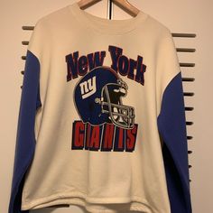 New Giants Shirt White And Royal Blue Blue Shirt With Graphic Print For Game Day, Blue Relaxed Fit Tops For Game Day, Blue Graphic Print Shirt For Game Day, Blue Cotton Shirt For Game Day, Blue Crew Neck Shirt For Game Day, Blue Relaxed Fit Sweatshirt For Game Day, Blue Retro Sweatshirt For Sports, Retro Blue College Sweatshirt, Vintage Nfl Shirts