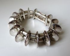 "An amazing piece of modern silver-smithing design history. A beautiful piece of Scandinavian design. Very much in the atomic, geometric style of previous artisans from the 50s & 60s. Stunning statement bracelet designed by Danish silversmith, Lars Sogard Nielsen, circa 1990 (Copenhagen)  Dimensions of bracelet: Weight 127.5 grams Length 7.5\"  Width 0.9\" (23mm) Slide lock catch with figure of 8 safety. I would suggest a wrist size of 6-7\" would fit his piece. A rare find, Lars's jewellery doe 70s Mid Century Modern, Vintage Modernist Jewelry, Silver Smithing, Hand Cuff Bracelet, Slide Lock, Modernist Jewelry, Design History, Statement Bracelet, Skull Ring