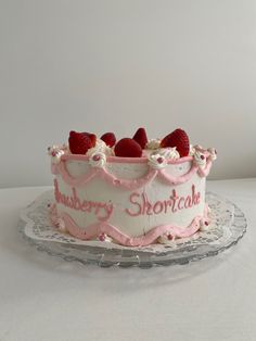 a strawberry shortcake cake on a glass plate