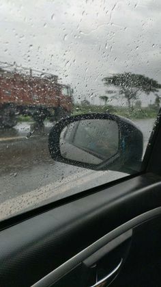 rain is falling on the windshield of a car