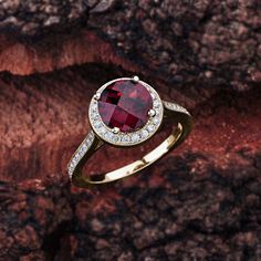 This garnet engagement ring in 14K white gold features a round garnet center stone that is complemented by brilliant white, sparkly diamond side stones. Garnet Engagement Details: 100% Handmade in the USA Center Stone - Garnet (2.00 carat AAA / VS) Metal - 100% Solid 14K (In Rose, Yellow, or White) Diamond Side Stones: Carat Weight - 0.33 carat total weight Shape - Round Cut Diamonds Color - G - H Clarity - SI1 Finger Size: We can make this setting in any finger size you need! Contact us if you Diamond Ring With Center Stone And Lab-created Ruby, Round Diamond Ring With Center Lab-created Ruby, Elegant Garnet Birthstone Ring With Center Stone, Ruby Ring With Diamond Accent Stones, Elegant Ruby Halo Ring Round Cut, Garnet Rings With Brilliant Cut In Fine Jewelry Style, Garnet Rings With Brilliant Cut Fine Jewelry, Lab-created Ruby Diamond Ring With Accent Stones, Garnet Rings In Brilliant Cut Fine Jewelry